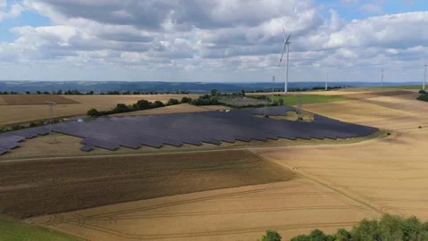 Solar panel station, wind turbine park, agriculture field with windmills, energy Stock Footage 314060806