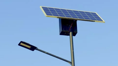 A solar panel street light installation that harnesses renewable energy for Stock Footage 306061895