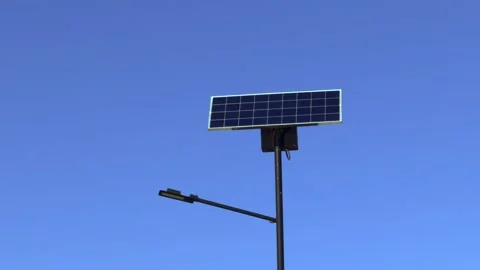 A solar panel street light installation that harnesses renewable energy for Stock Footage 306062791