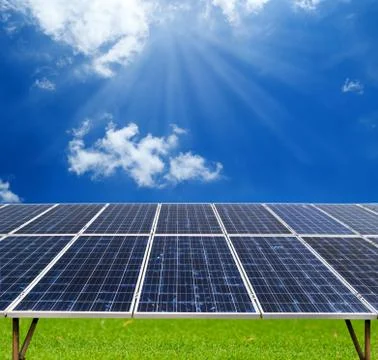 Solar panel with sunlight and clouds on blue sky Stock Photos