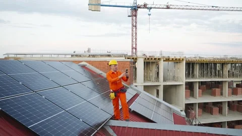 Solar panel technician taking a selfie on a rooftop Stock Footage 343894916