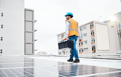 Solar panel, tool box and electricity with man on roof top for renewable energy Stock Photos
