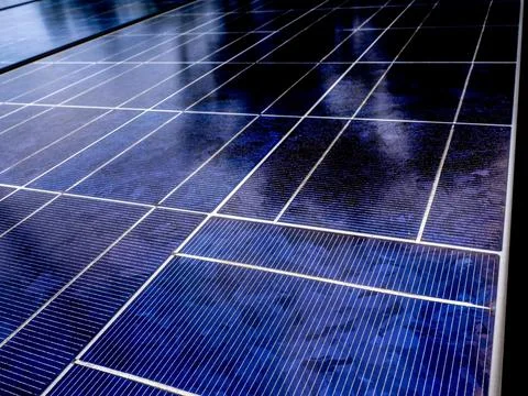 Solar panel with tree shadow. Blue solar energy plate detail for green electr Stock Photos