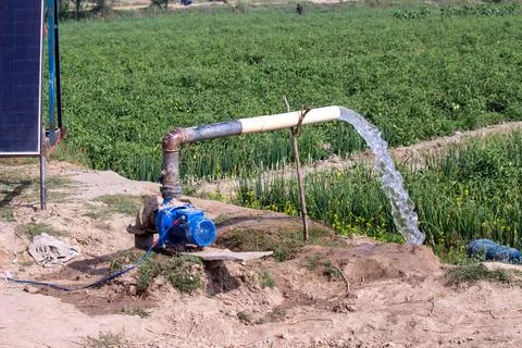 Solar panel water pump irrigation system in rural agricultural field Stock Photos