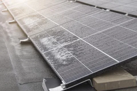 Solar panel in winter. Solar panels are covered with snow on the roof of the Stock Photos