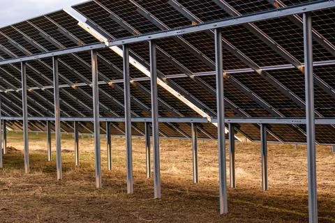 Solar Panels Aligned on Metal Frames in an Open Outdoor Setting Stock Photos