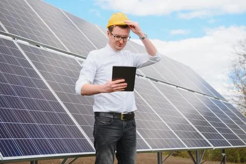 Solar panels and blue sky.Man standing near solar panels. Solar panel produ.. Stock Photos