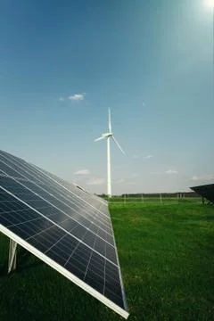 Solar panels and a windmill generate electricity from the sun Stock Photos