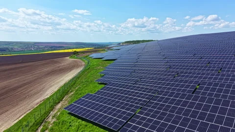 Solar panels are installed on a hillside in a rural area during daytime with Stock Footage 342511425