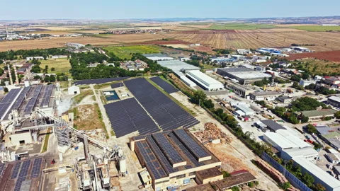 Solar panels are installed on rooftops and ground in an industrial area Stock Footage 342334153