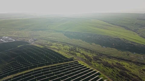 Solar panels are placed in straight rows on land Stock Footage 329995125