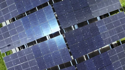 Solar panels arranged in a grid on a rooftop in the afternoon sun, capturing Stock Footage 337917557