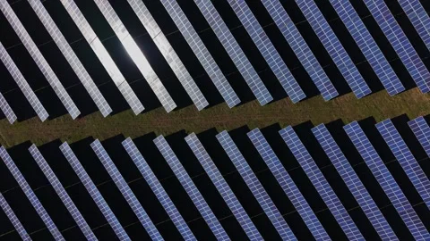 Solar panels arranged in neat rows under sunlight at a facility 스톡 동영상 334029856