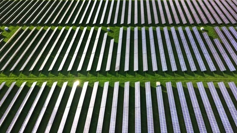 Solar panels arranged in orderly rows on green field from above Stock Footage 325088900