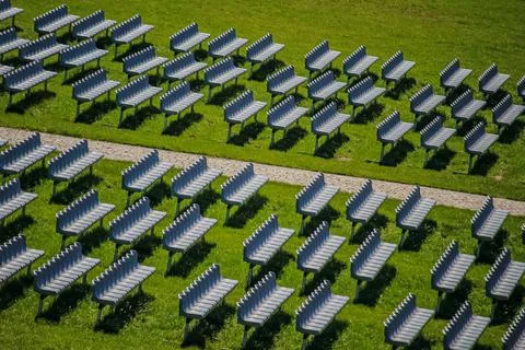 Solar panels arranged in rows on green field Stock Photos