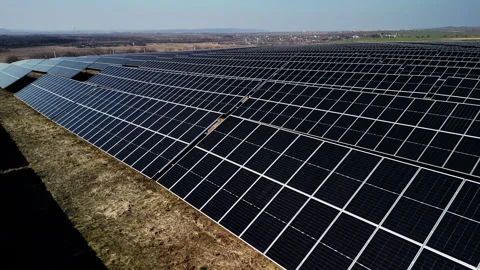 Solar panels arranged in rows on a hillside, capturing sunlight in a renewable 스톡 동영상 332894317