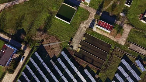 Solar panels arranged in rows in an open field during daylight hours Stock-Footage 334028129