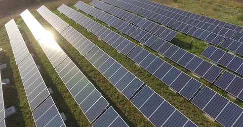 Solar panels array at solar farm alternative clean renewable energy 4K drone Stock Footage