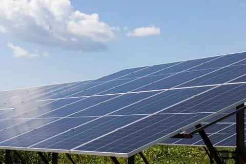 Solar panels on the background of a cloudy sky on a sunny day. Close-up Stock Photos