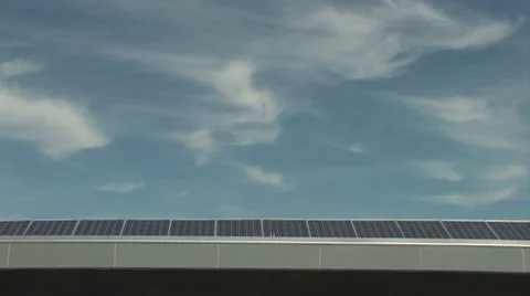 Solar panels from below against wispy clouds Stock Footage 7765180
