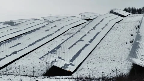 Solar panels blanketed in snow, set amidst a snowy field Stock Footage 318317472