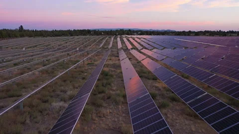 Solar panels with colorful sunset, pulling back on camera Stock Footage 160889677