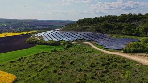 Solar panels cover fields in a renewable energy project in the countryside Stock Footage 338277182