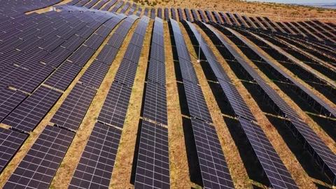 Solar panels cover land in a large solar farm in an open area Stock Footage 344540831