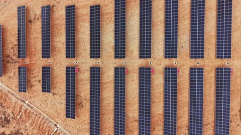 Solar panels cover a large area in a desert environment, showing an organized Stock Footage 336487579