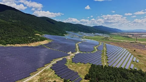 Solar panels cover a large area in the valley near mountains Stock Footage 339162806