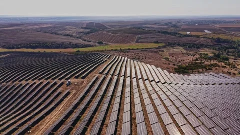 Solar panels cover a large area in an open landscape during daylight Stock Footage 344540885