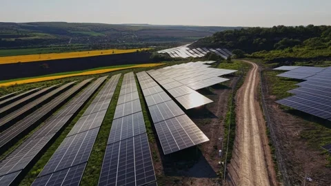 Solar panels cover a large field near rolling hills and farmland Video stock 338277324