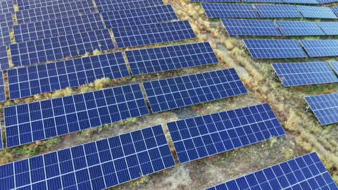 Solar panels cover a large field under the sun in a rural area showing clean Stock Footage 341699637