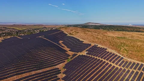 Solar panels cover a large field in a rural area during sunny weather Stock Footage 344540587