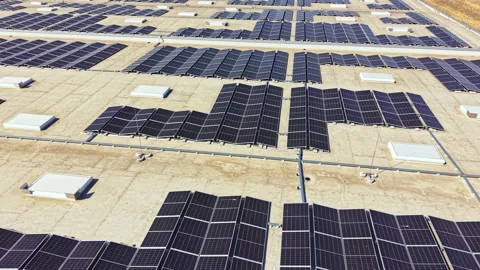 Solar panels cover a large flat roof in a sunny location during midday with 動画素材 342735457