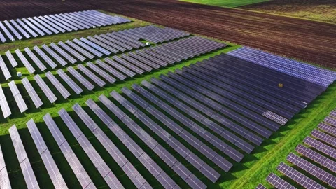 Solar panels cover vast fields in an aerial view of renewable energy site Stock Footage 325087407