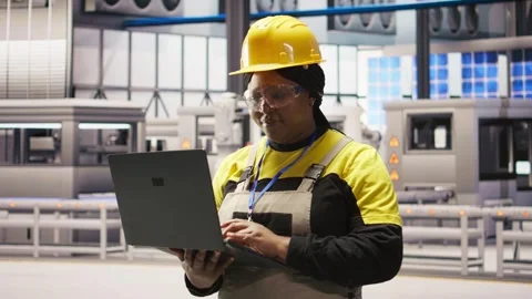 Solar panels factory engineer analyzes performance data with laptop Stock Footage 308723660