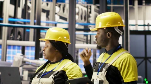 Solar panels factory engineering team analyzes performance data on laptop Stock Footage 307366406