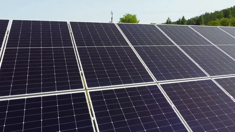 Solar panels farm on a hillside under a clear blue sky, clean energy concept. 動画素材 336237906