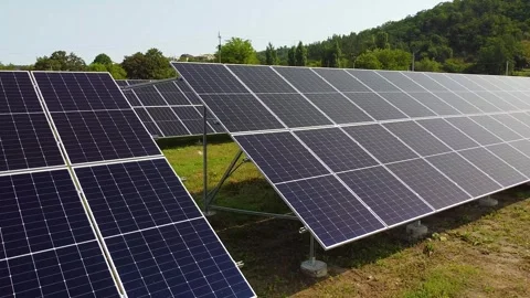 Solar panels farm on a hillside under a clear blue sky, clean energy concept. 動画素材 336237909