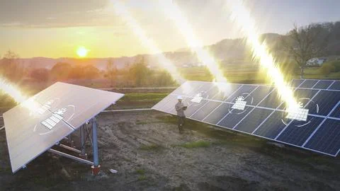 Solar panels farm at sunset, engineer technician working on site with tablet Foto stock