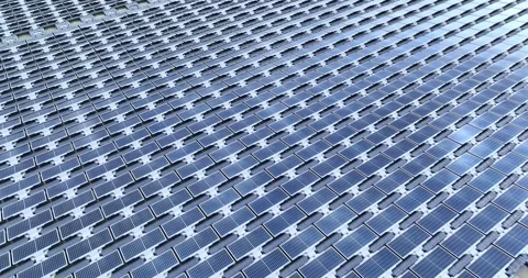 Solar panels floating in a lake seen from a drone perspective,View of the flo Stock Footage 257043530