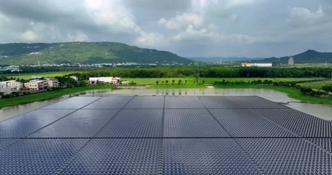 Solar panels floating in a lake seen from a drone perspective,View of the flo Stock Footage 257043648
