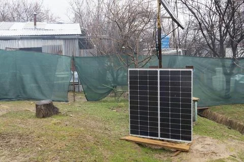 Solar Panels Installed in Backyard Garden for Renewable Energy Stock Photos