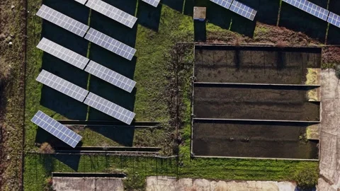 Solar panels installed in field with empty water channels nearby Vidéo 334027924