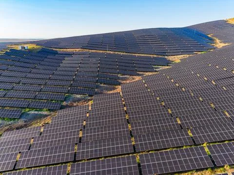 Solar panels installed on a hillside for renewable energy generation during.. Stock-Fotos