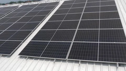 Solar panels installed on industrial warehouse roof generating renewable energy Stock-Footage 334160773