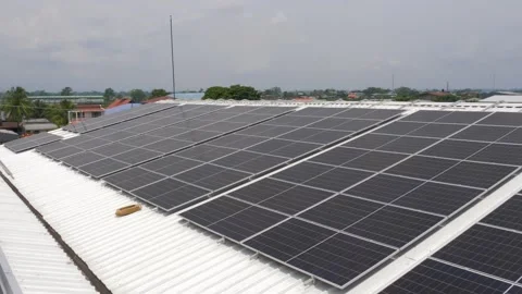 Solar panels installed on industrial warehouse roof generating renewable energy Video stock 334160798
