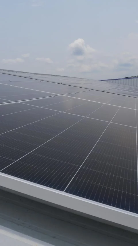 Solar panels installed on industrial warehouse roof generating renewable energy Video stock 334160837