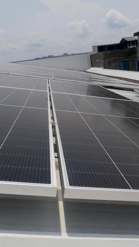 Solar panels installed on industrial warehouse roof generating renewable energy Video stock 334160855